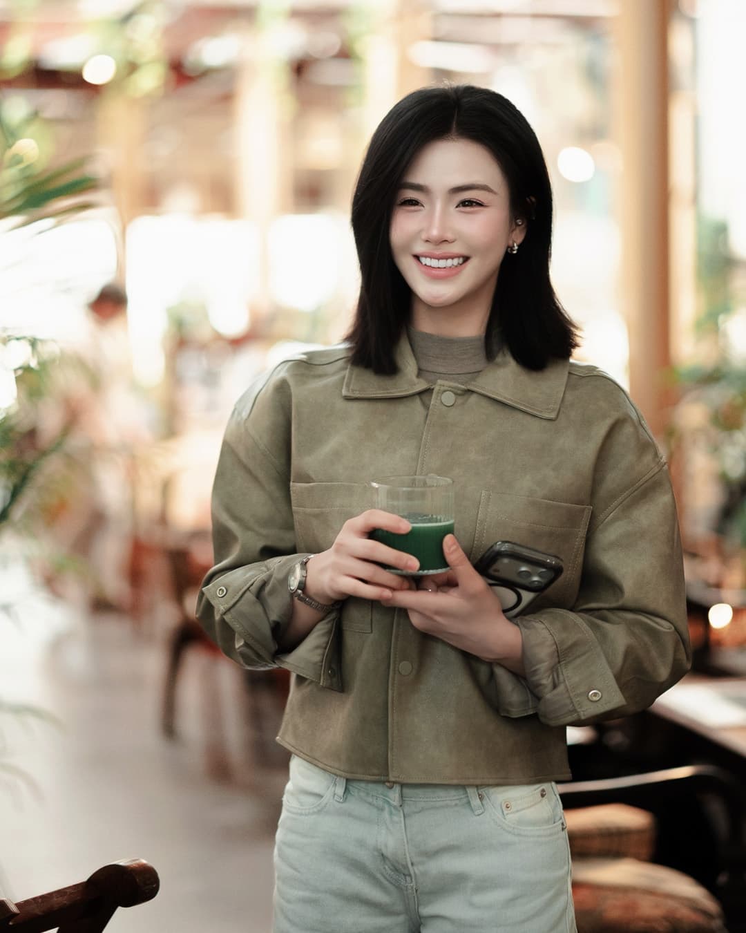 Khun Pim smiling at a café
